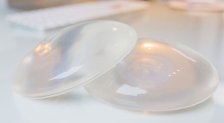 Silicone breast implants on table.