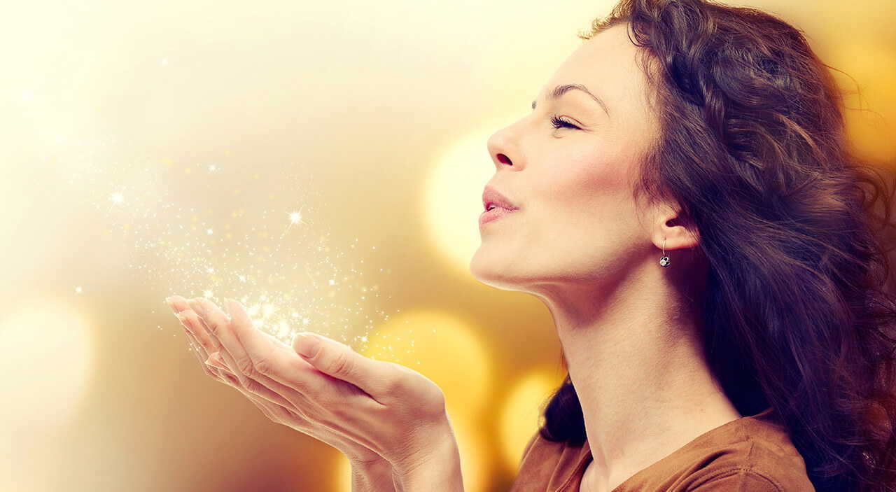 Woman celebrating with sparkles, embracing her new look after plastic surgery.